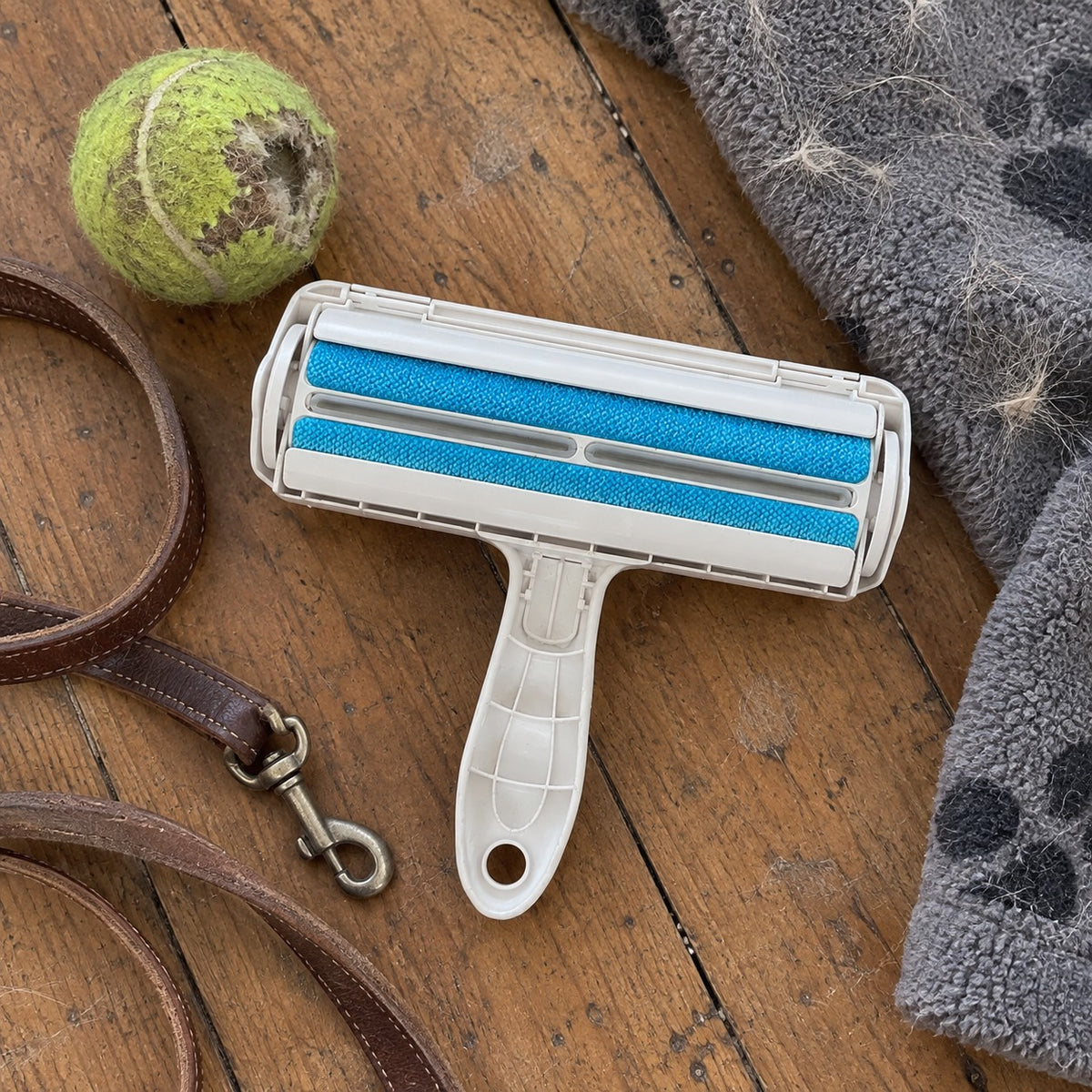 Top view of the pet hair roller showing two blue brush strips and the grip handle